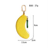 Yellow fruit-shaped PU leather coin purse keychain with a silver-colored loop.