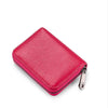 A vibrant pink leather zipper card holder wallet shown from above.