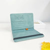 A teal vintage PU leather ID wallet with a fold-over design and a black accent.