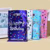 A set of ten colorful, foil-lined birthday party gift bags in various bright colors and designs.