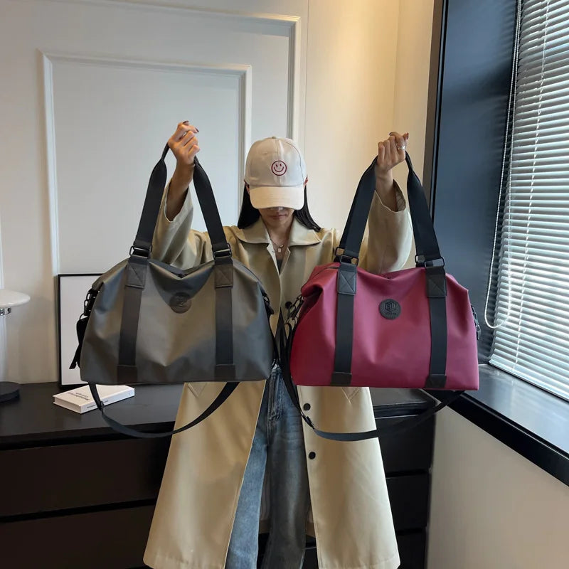 A woman holds up a pink and gray Versatile Oxford Cloth Travel Tote Bag against a window backdrop.