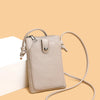 A beige compact PU leather crossbody bag with a zipper closure and a long strap is shown against a light background.