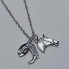 Silver necklace with a cowboy boot, hat, and horseshoe keychain set.