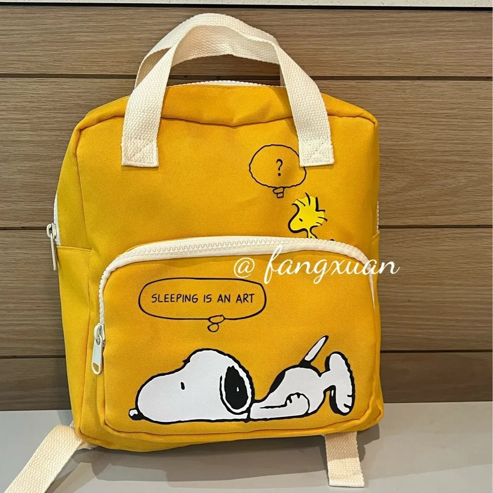 A yellow canvas shoulder bag featuring a Snoopy cartoon design with a question mark and text reading Sleeping is an art.