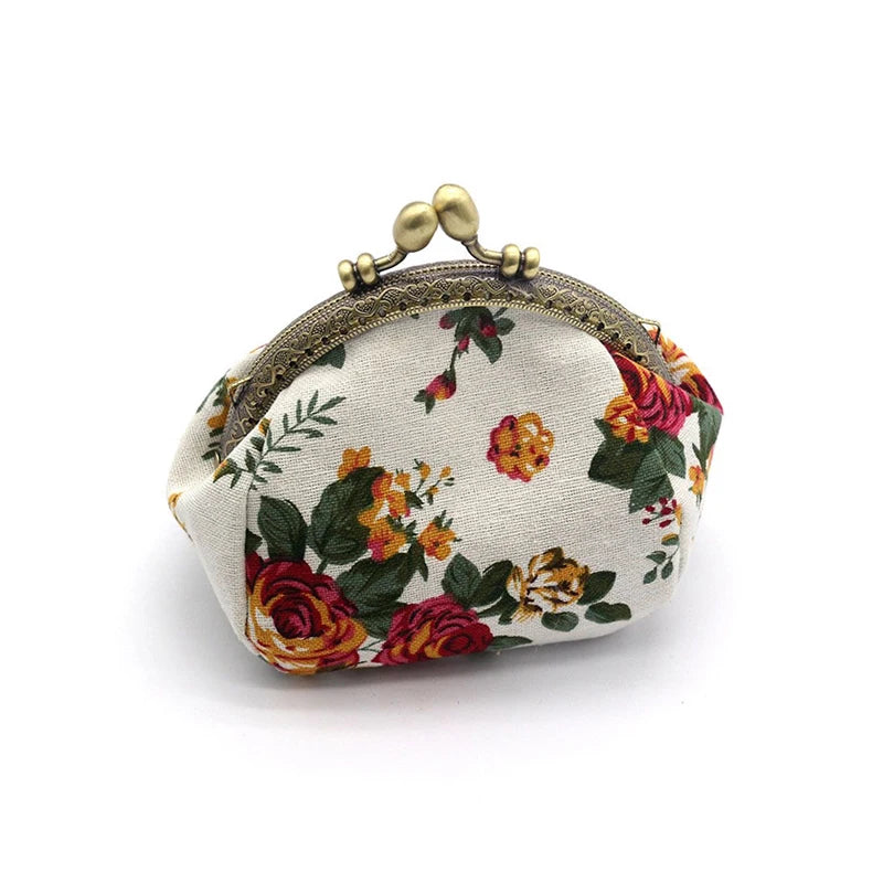 A vintage rose print canvas coin purse with gold-toned hardware.