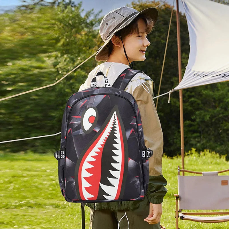 A person wearing a beige shirt and hat is carrying a black waterproof anti-theft casual travel backpack outdoors.