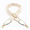 A beige canvas cotton bag strap with gold-toned metal hooks shown in an X-shape.
