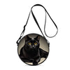 A black cartoon cat is featured on a round crossbody bag with a black strap.