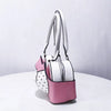 A pink and white shoulder bag featuring a bow silhouette and polka dot accents.