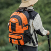 A person wearing a beige hat and a bright orange hiking backpack is shown from the back in an outdoor setting.