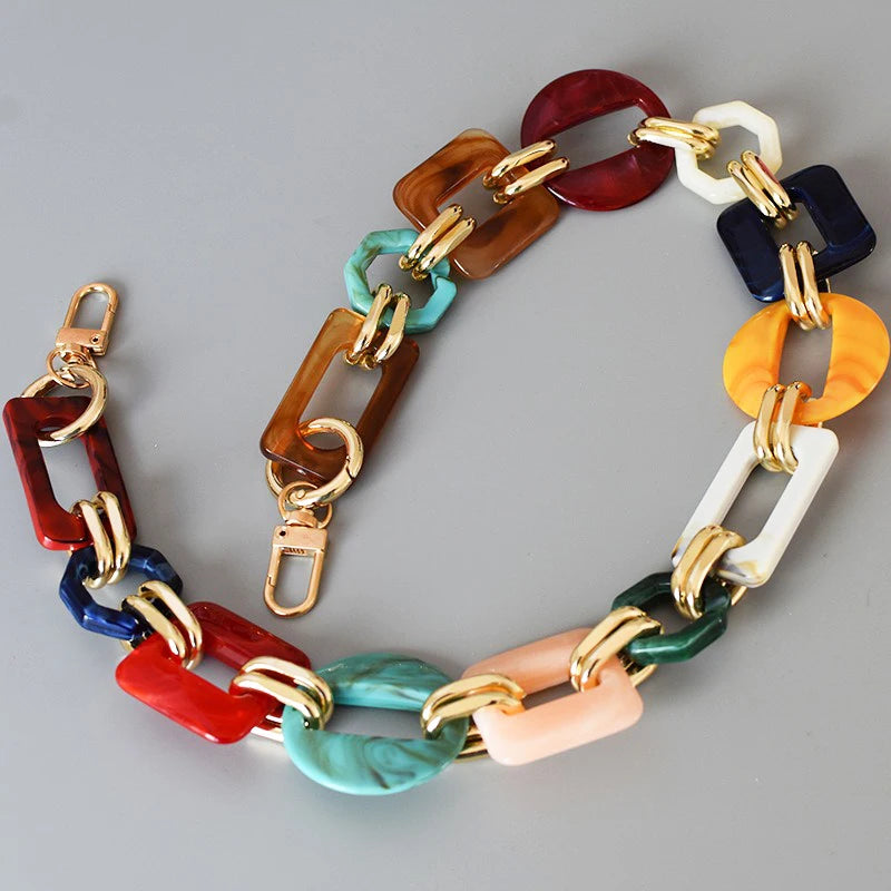 A multi-color acrylic chain strap featuring various shades of red, brown, blue, green, and white.