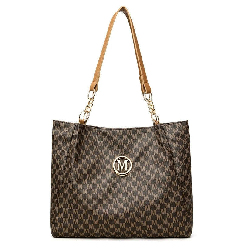 A brown geometric monogram tote bag with leather handles and a textured fabric pattern.