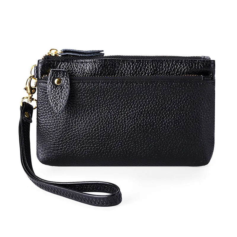 Black genuine leather wristlet clutch wallet with a zipper closure and gold hardware