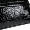 Close-up of a black crocodile print PU leather clutch handbag.