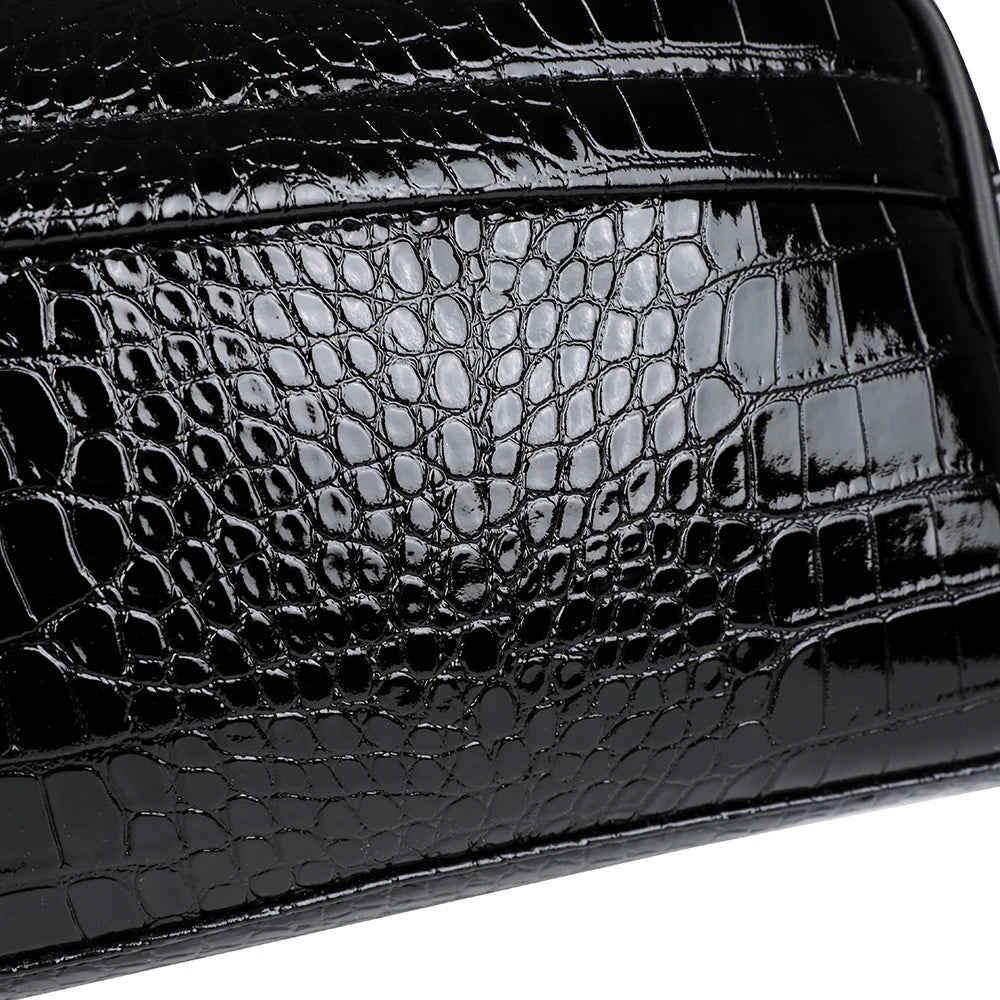 Close-up of a black crocodile print PU leather clutch handbag.