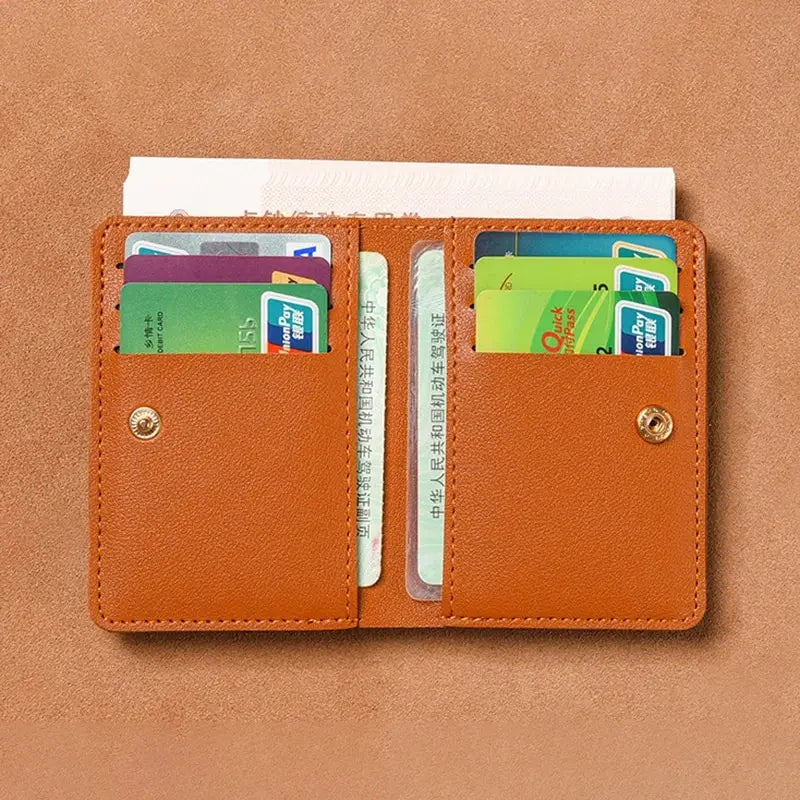 A brown PU leather small wallet holding several credit cards and an ID card.