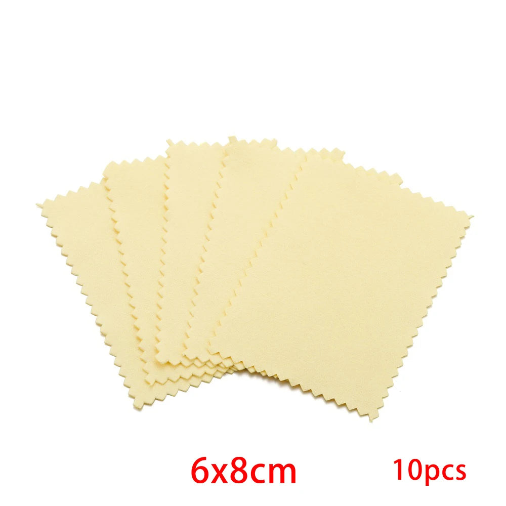 A set of ten yellow polishing cloths for silver and gold jewelry, laid out in a fan shape.