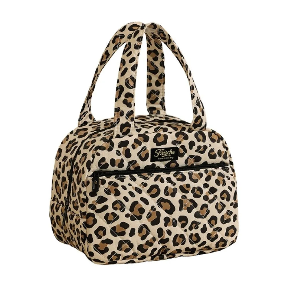 A beige leopard print insulated lunch tote bag with two shoulder straps.