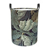 A vintage floral laundry hamper with a dark patterned fabric and black handles.