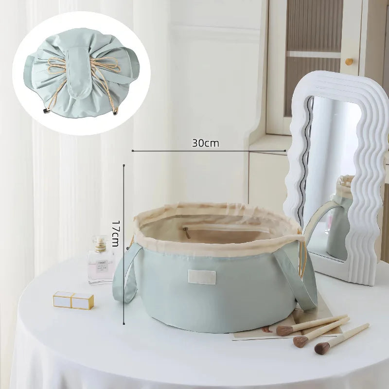 Light blue instant-open flat lay makeup organizer bag with a drawstring closure displayed on a white table.