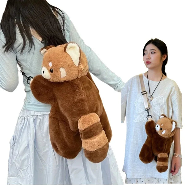 A person is holding a brown red panda plush backpack in a light-colored outfit.