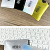 A collection of various colored RFID blocking card sleeves displayed on a wooden surface and a laptop keyboard.