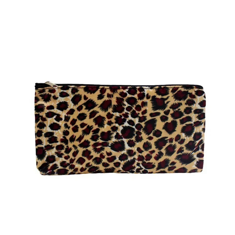 A rectangular leopard print zippered cosmetic bag in brown and black tones.