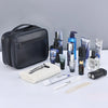 A black portable PU leather cosmetic organizer bag with various grooming products and accessories displayed on a white surfac