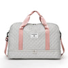 A light gray nylon travel duffle bag with pink straps and a quilted pattern.