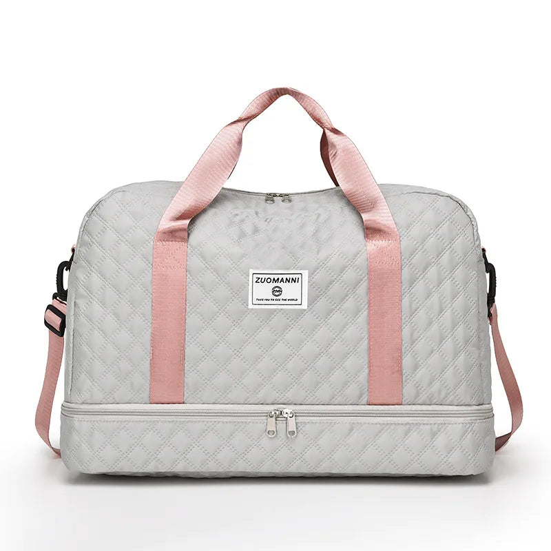 A light gray nylon travel duffle bag with pink straps and a quilted pattern.