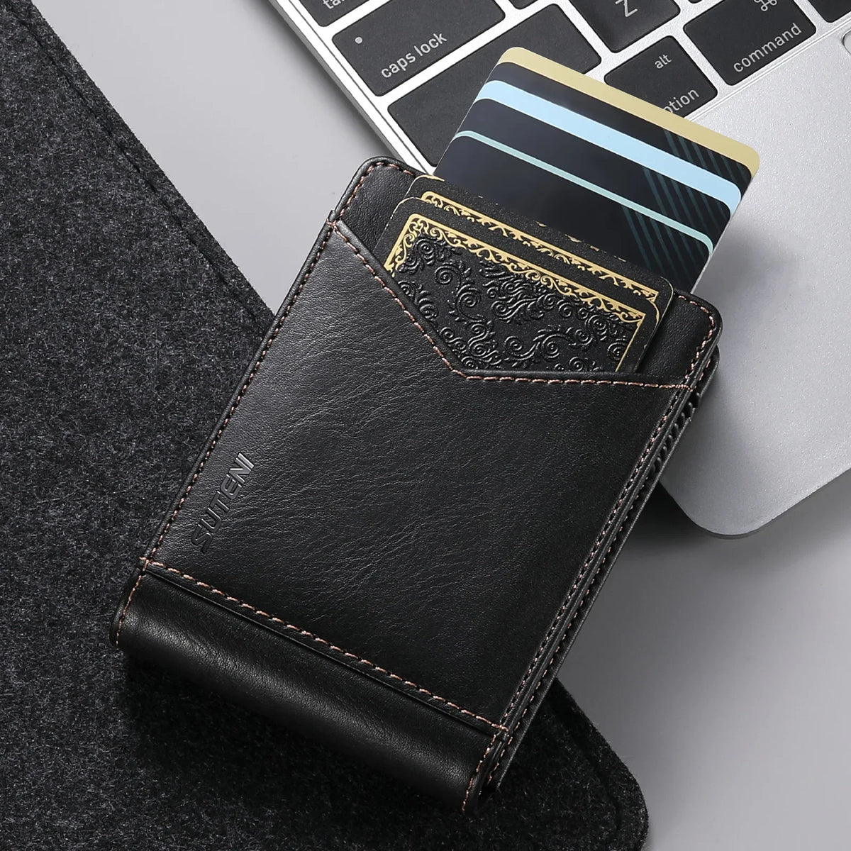 A black PU leather card holder with a gold-edged card is shown next to a laptop keyboard.