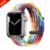 A black Apple Watch is shown attached to a colorful braided stretch band for the watch.