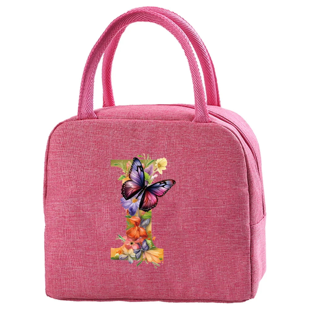 A pink insulated canvas lunch bag with pink fabric handles and a floral butterfly design.