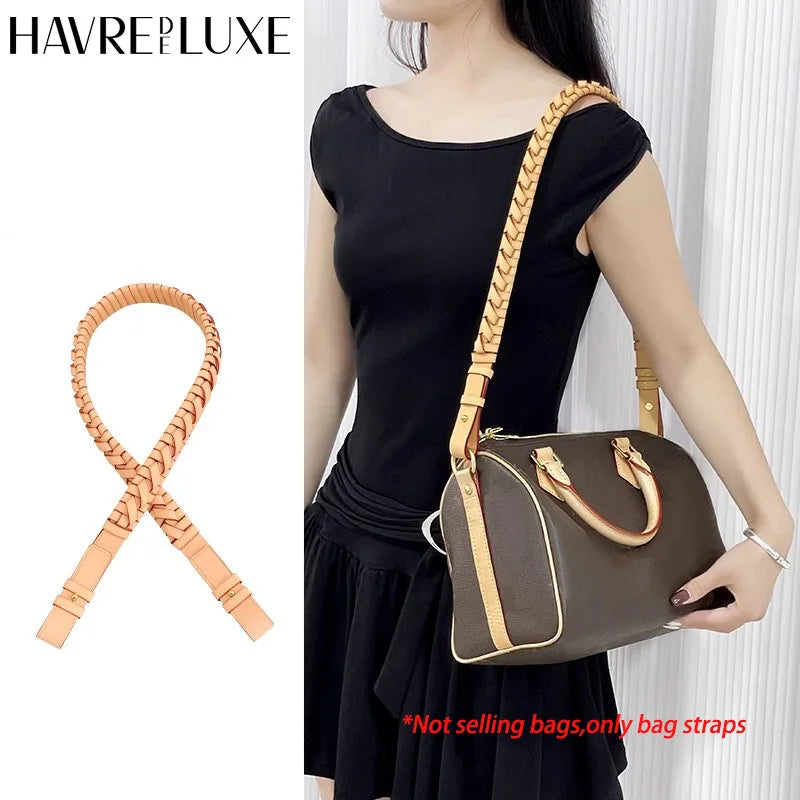 A woman models a brown leather shoulder bag with a matching strap against a white background.