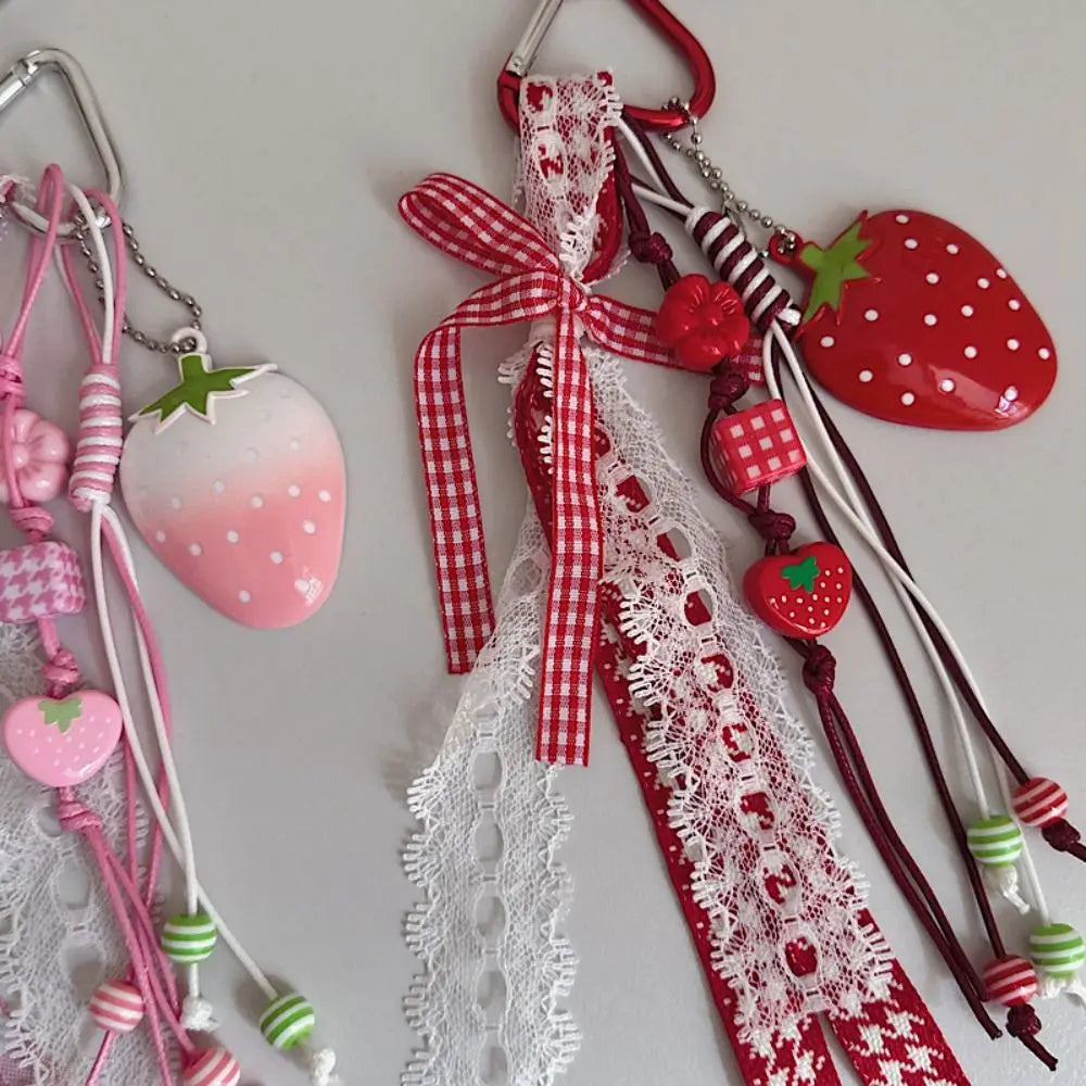 Red and white lace strawberry bag charm keychains with pink and green accents