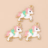 Two gold-toned unicorn horse charm pendants featuring white bodies and pink and mint green accents.