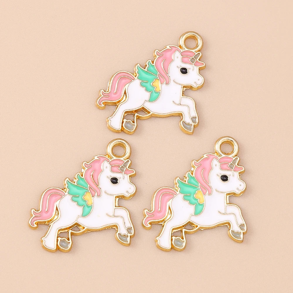 Two gold-toned unicorn horse charm pendants featuring white bodies and pink and mint green accents.