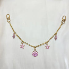 Gold chain necklace with pink gemstone charms and a starfish pendant