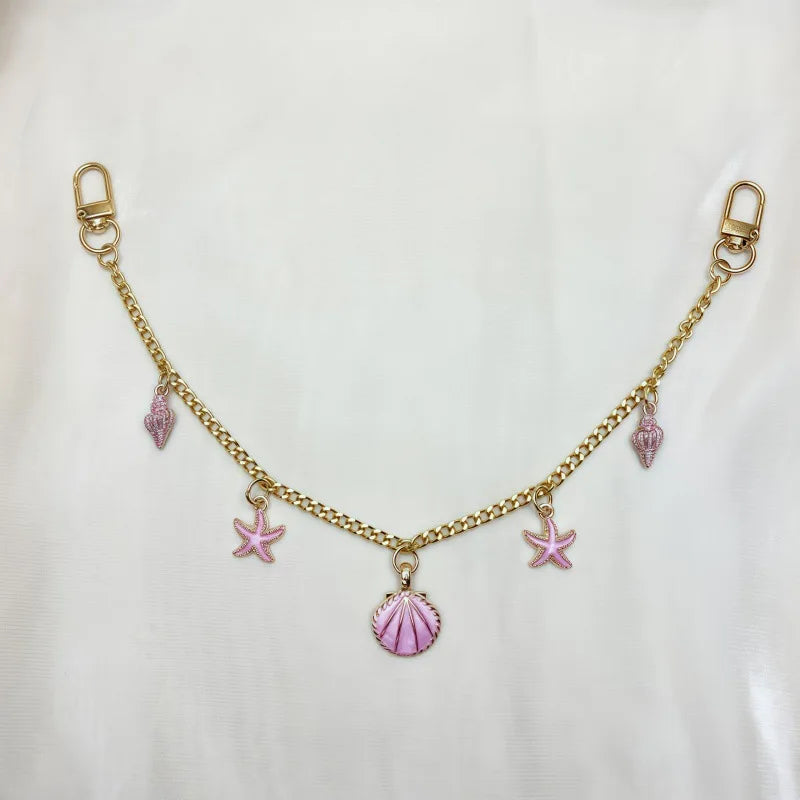 Gold chain necklace with pink gemstone charms and a starfish pendant