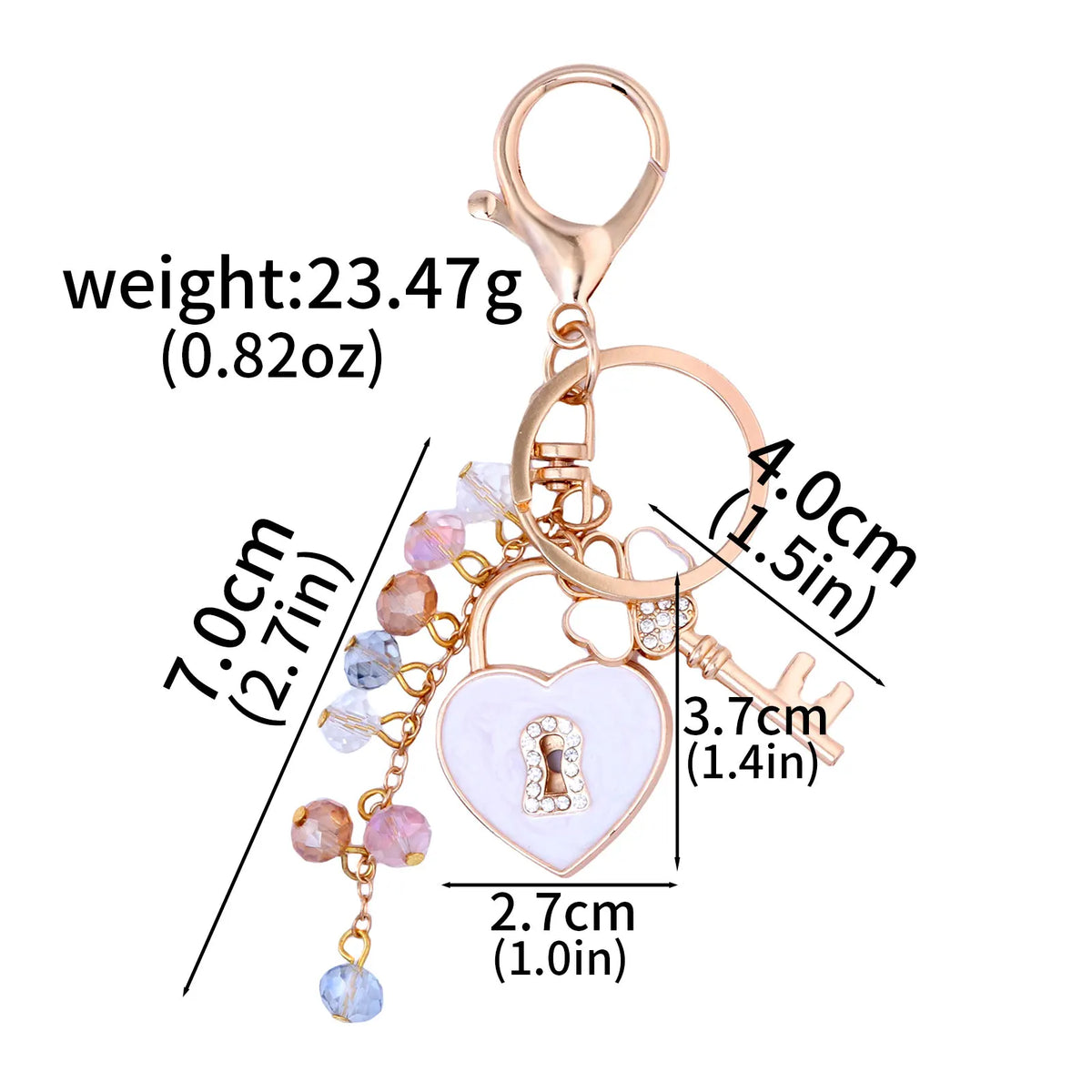 Gold-toned key chain featuring a bow, heart charm, and dangling beads with measurements.