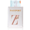 A light pink leather passport holder with gold lettering and a rose design, next to an ID card.