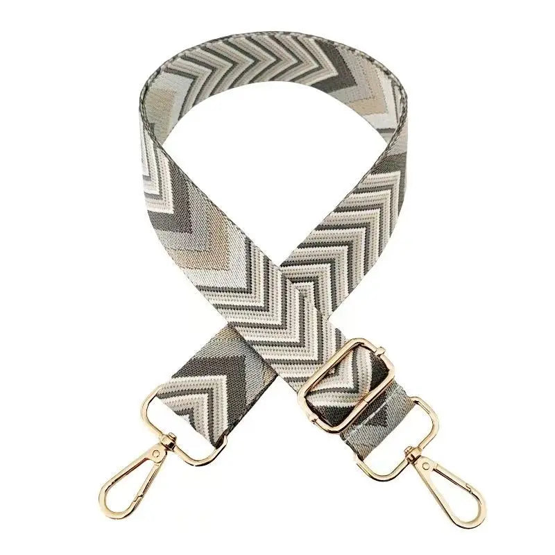 A beige and gray patterned nylon strap for bags and luggage