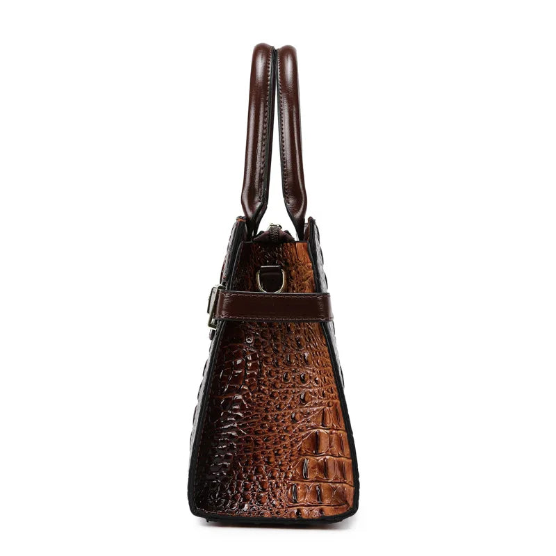 A brown crocodile embossed PU leather shoulder handbag set with leather straps.