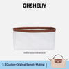 A white leather organizer insert for a mini pot or laptop sleeve with a brown trim.