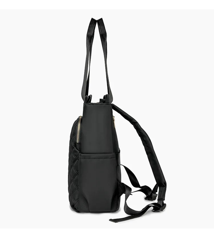 A black quilted women's backpack tote with black straps.