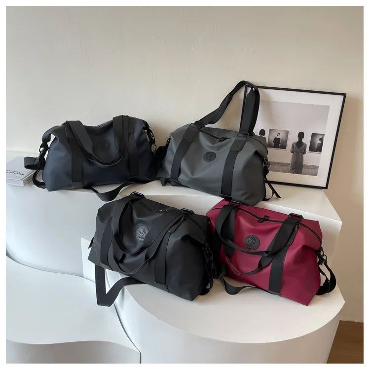 A collection of black and burgundy Versatile Oxford Cloth Travel Tote Bags displayed on a white surface.