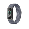 A dark gray stretchy nylon watch band with a black display showing 12:58 and 7,546 steps.