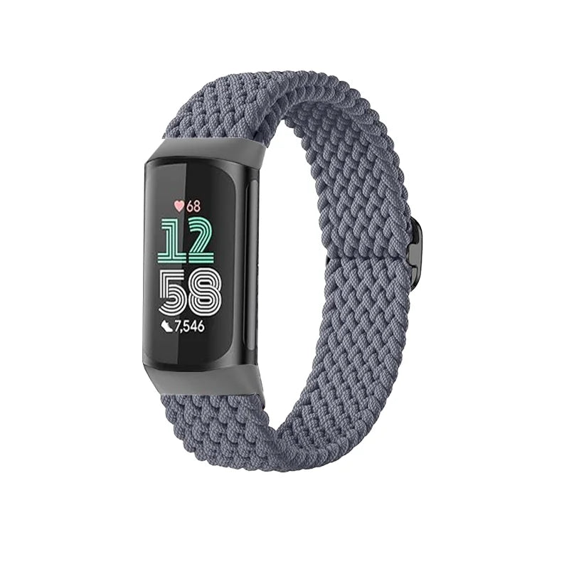 A dark gray stretchy nylon watch band with a black display showing 12:58 and 7,546 steps.