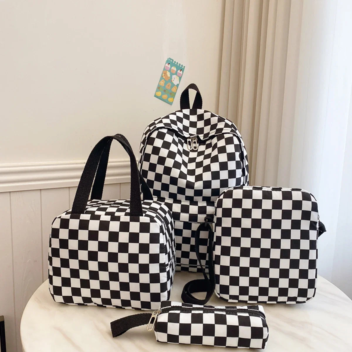 A black and white checkerboard multi-pocket backpack displayed on a white surface.