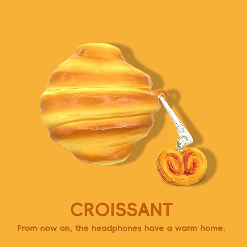 A golden croissant is shown against an orange background with text below it.